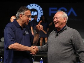 Fiat Chrysler Automobiles CEO Sergio Marchionne, left, and United Auto Workers president Dennis Williams shake hands during a ceremony to mark the opening of contract negotiations in this July 14, 2015 photo. The UAW approved a new four-year contract with Fiat Chrysler, on Thursday, Oct. 22, 2015, with UAW members at Fiat Chrysler's U.S. factories voting 77 per cent in favour of the agreement, the union said. The contract covers 40,000 workers at 23 U.S. factories.