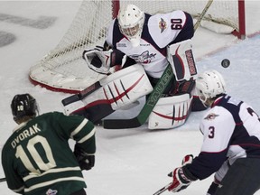 Windsor goalie Michael Giugovaz stops a shot from London's Christian Dvorak, while Windsor's Liam Murray looks on in the first period of OHL action between the Windsor Spitfires and the visiting London Knights at the WFCU Centre, Sunday, Oct. 25, 2015.