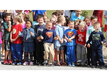 A handful of lucky students at St. Joseph elementary school in River Canard had a chance to get a ride in some high-priced sports cars on Wednesday, Oct. 7, 2015. A canned food drive was held at the school. For every 10 cans brought in the student received a ticket for a chance to ride in one of the cars. A group of students cheer as the cars rev up their engines.  (DAN JANISSE/The Windsor Star)