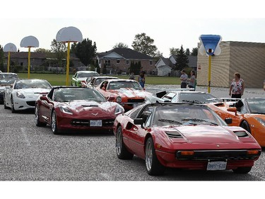 A handful of lucky students at St. Joseph elementary school in River Canard had a chance to get a ride in some high-priced sports cars on Wednesday, Oct. 7, 2015. A canned food drive was held at the school. For every 10 cans brought in the student received a ticket for a chance to ride in one of the cars. Some of the fancy cars are shown during the event.  (DAN JANISSE/The Windsor Star)