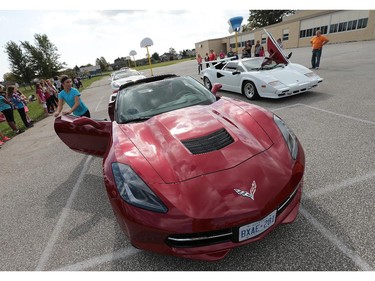 A handful of lucky students at St. Joseph elementary school in River Canard had a chance to get a ride in some high-priced sports cars on Wednesday, Oct. 7, 2015. A canned food drive was held at the school. For every 10 cans brought in the student received a ticket for a chance to ride in one of the cars. A Corvette (L) and a 1988 Lamborghini Countach are shown during the event.  (DAN JANISSE/The Windsor Star)