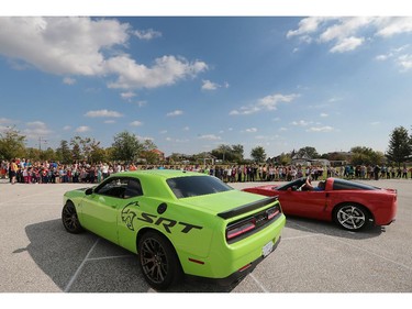 A handful of lucky students at St. Joseph elementary school in River Canard had a chance to get a ride in some high-priced sports cars on Wednesday, Oct. 7, 2015. A canned food drive was held at the school. For every 10 cans brought in the student received a ticket for a chance to ride in one of the cars. A Dodge Charger SRT Hellcat (L) and a Corvette are shown during the event.  (DAN JANISSE/The Windsor Star)