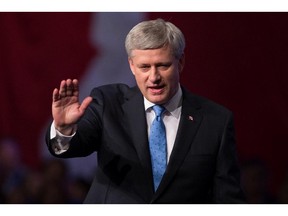 Conservative Leader Stephen Harper waves as he leaves the stage after addressing supporters at an election night gathering in Calgary, Alta., on Monday October 19, 2015.