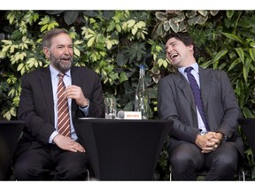 Liberal Leader Justin Trudeau laughs with NDP Leader Tom Mulcair as he speaks during a panel discussion on youth voting, Wednesday, March 26, 2014 in Ottawa. Mulcair is reiterating his openness to a possible coalition with the Liberals if it is necessary to topple Stephen Harper's Conservatives.