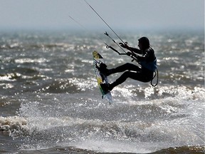 A kitesurfer jumps a wave on Lake Erie near Kingsville on a windy day.