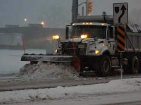 A plow leaves the City of Windsor Crawford yard during a heavy snowfall.