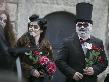 Bride and groom, Kasandra Kehoe, left, and Craig Price, tie the knot at Windsor Grove Cemetery while wearing costumes for Halloween, Saturday, Oct. 31, 2015.