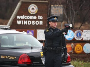 OPP Const. Troy Roberts is pictured with a radar gun  on Huron Church Road north of Todd Lane in Windsor, Ont. in this file photo.