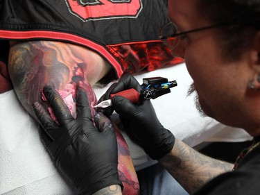 attoo artist John Wayne works on the arm of Scott Robinson at his studio in Belle River on Wednesday, March 4, 2015.        (TYLER BROWNBRIDGE/The Windsor Star) Windsor Ink
