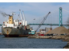 Workers on the freighter Vamand Wave use a crane to unload a massive cargo of stone on the West Windsor waterfront under idea weather conditions Friday.  With winter approaching, marine traffic along the Detroit River has been brisk with many freighters heading to ports before the snow flies.