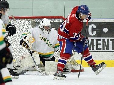 The Lakeshore Canadiens Steven Sartor deflects the puck at the Wallaceburg Lakers Derion Ducedre at the Atlas Tube Centre in Lakeshore on Friday, October 16, 2015.                                      (TYLER BROWNBRIDGE/The Windsor Star)