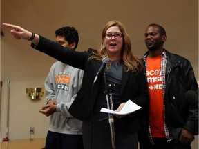 NDP candidate Tracey Ramsey is joined on stage by her husband Germaine, right, and their son Maxwell after defeating Conservative Jeff Watson in Essex on Oct. 19, 2015.