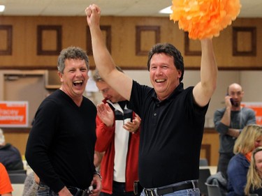 Tracey Ramsey supporters Roland Kiehne and Chris Taylor (right) celebrate after it was announced she defeated incumbent Jeff Watson in Essex on Monday, October 19, 2015.