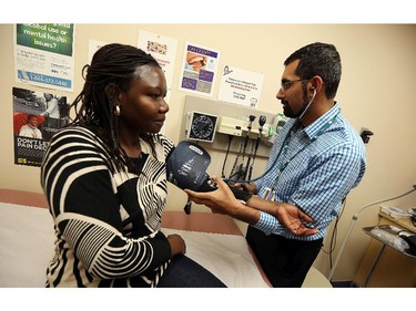 Dr. Mohammed Hussain sees patient Jean Moro at City Centre Health Care in Windsor on Tuesday, October 6, 2015. The clinic is housed in the CMHA office but operates as a normal clinic.                                     (TYLER BROWNBRIDGE/The Windsor Star)