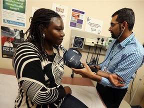 Dr. Mohammed Hussain sees patient Jean Moro at City Centre Health Care in Windsor on Tuesday, October 6, 2015. The clinic is housed in the CMHA office but operates as a normal clinic.