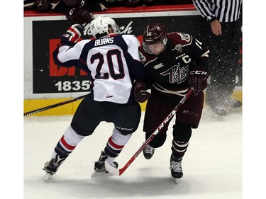 The Windsor Spitfires Andrew Burns collides with the Peterborough Petes Eric Cornel at the WFCU Centre in Windsor on Thursday, October 8, 2015.                                      (TYLER BROWNBRIDGE/The Windsor Star)