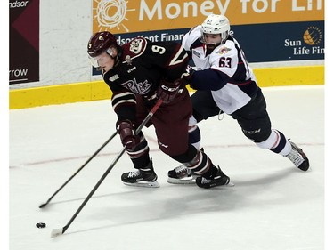 The Windsor Spitfires Bradley Latour chases the Peterborough Petes Adam McPhail at the WFCU Centre in Windsor on Thursday, October 8, 2015.                                      (TYLER BROWNBRIDGE/The Windsor Star)