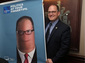 Windsor Mayor Drew Dilkens holds a Windsor Star 2.0 poster as presented by Windsor Star Editor-In-Chief Marty Beneteau on October 13, 2015.