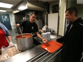 David Dunn, owner of Riviera Pizza on Ottawa Street serves up soup to guest Don Lawson at  the Downtown Mission in Windsor, Ontario on Oct. 1, 2015.