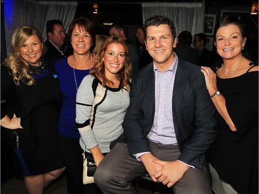 Former Windsor Spitfires captain Ryan Donally is the centre of attention while posing with Beth Jessop, left, Tammy Dufour, Amy Djarmocky and Joanne Duff, right, during New Windsor Star launch gala at News Cafe October 15, 2015.