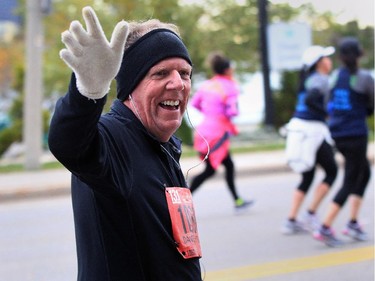 Dave Hitchcock waves to friends along Riverside Drive West at Ferry Street during the 2015 Detroit Free Press Talmer Bank Marathon Sunday October 18, 2015.  (NICK BRANCACCIO/Windsor Star)