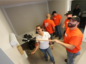 Tiffany Owen , outreach worker with  Windsor Residence for Young Men,  and    Mark Belanger, store manager of Home Depot  at Walker and Division,  along with volunteers, paint  the Windsor Residence for Young Men during.   Home Depot and a team of volunteers  are spending two days painting the residence and enhancing the interior of the home.