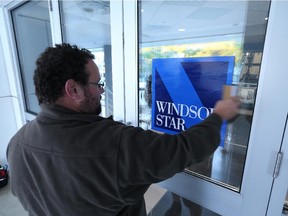 An employee from FastSigns placed the new Windsor Star logo on the front doors at 300 Ouellette Ave. during the launch of Windsor Star's 2.0 platform on October 13, 2015.
