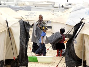 Syrian refugees are seen in the Zaatari refugee camp, a seven-square-kilometre (2.8-square-mile) camp that is home to more than 100,000 refugees in this 2014 file photo.