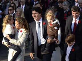Prime Minister-designate Justin Trudeau, his wife Sophie Gregoire-Trudeau and their children Ella-Grace, Hadrien and Xavier lead the new Liberal cabinet to Rideau Hall in Ottawa on Wednesday, Nov. 4, 2015. THE CANADIAN PRESS/Sean Kilpatrick