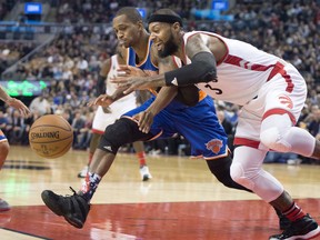 Toronto Raptors forward James Johnson (3) and New York Knicks forward Lance Thomas battle for a loose ball during first half NBA action in Toronto Tuesday November 10, 2015. THE CANADIAN PRESS/Frank Gunn