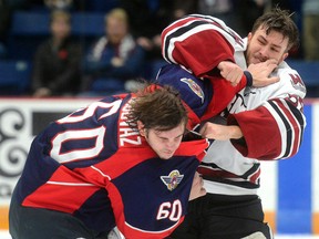 Guelph Storm goaltender Justin Nichols, right, fights at centre ice with Windsor Spitfires goaltender Michael Giugovaz Sunday, November  8, 2015 at the Sleeman Centre. A line brawl broke out with four seconds left in Windsor's 4-0 victory. Tony Saxon, Guelph Mercury