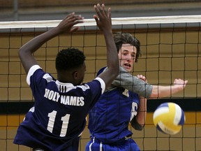 Holy Names' Michael Okoko, left, can't block a shot from Kennedy's Ryan Acott during high school boys volleyball playoff action at Kennedy Tuesday, November 10, 2015.