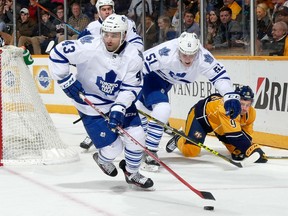 Nazem Kadri #43 of the Toronto Maple Leafs carries the puck behind the net during a game against the Nashville Predators during the first period at Bridgestone Arena on November 12, 2015 in Nashville, Tennessee.  (Photo by Frederick Breedon/Getty Images)