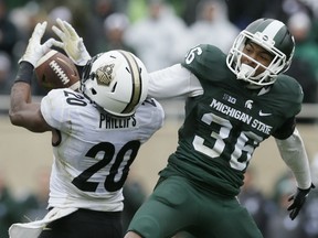 Windsor's Arjen Colquhoun, right, breaks up a pass intended for Purdue wide receiver Gregory Phillips (20) on the last play of the game in the second half of an NCAA college football game, Saturday, Oct. 3, 2015, in East Lansing, Mich. Michigan State defeated Purdue 24-21. (AP Photo/Carlos Osorio)