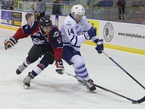 Windsor's Jalen Chatfield, left, checks Mississauga's Nathan Bastian during OHL action at the Hershey Centre in Mississauga Friday. (Bryon Johnson/The Mississauga News)