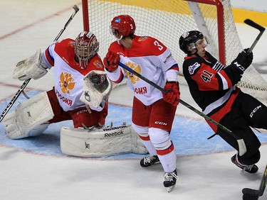 Team Russia goaltender Alexander Trushkov, left, makes a glove save as Team Russia's Ilya Devuk collides with Will Bitten of Team OHL in the first period at Windsor Family Credit Union Centre Monday November 16, 2015. The game was part of 2015 CHL Canada Russia Series.