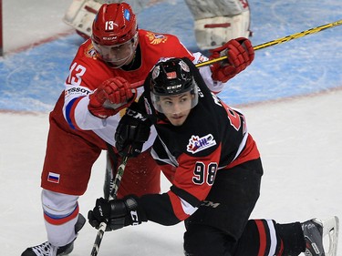 Windsor, Ontario. November 16, 2015. Victor Mete, front, of Team OHL collides with Kirill Pilipenko of Team Russia in the first period at Windsor Family Credit Union Centre Monday November 16, 2015.  The game was part of 2015 CHL Canada Russia Series.