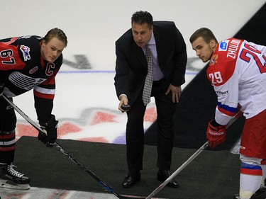 Windsor, Ontario. November 16, 2015.  Windsor Spitfires GM Warren Rychel drops the puck for the ceremonial face-off between Lawson Crouse, left, of Team OHL and Nikita Zhuldikov of Team Russia at Windsor Family Credit Union Centre Monday November 16, 2015. The game was part of 2015 CHL Canada Russia Series.