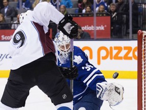 Toronto Maple Leafs goalie James Reimer (34) makes a save against Colorado Avalanche centre Matt Duchene (9) during first period NHL hockey action in Toronto on Tuesday, November 17, 2015. THE CANADIAN PRESS/Nathan Denette