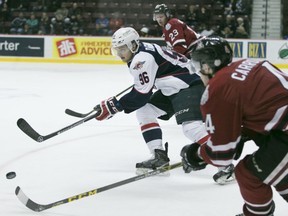 Windsor's Christian DiGiacinto battles for the puck with Guelph's Noah Carrol during OHL action between the Windsor Spitfires and the Guelph Storm at the WFCU Centre, Saturday, Oct. 31, 2015.   (DAX MELMER/The Windsor Star)