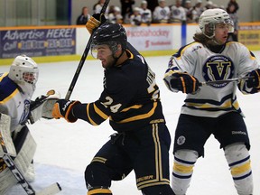 Lancers Dylan Denomme, centre, skates against Laurentian Voyageurs goalie Alain Valiquette, left, and Kaden Ruest during the first period of OUA hockey action from South Windsor Arena Friday November 6, 2015.