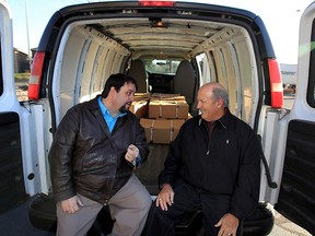 Rick Farrow, right, CEO and Chairman of Farrow, and Ron Dunn, Exec. Director Downtown Mission chat after Farrow donated a refurbished GMC commericial van to the Mission during a brief ceremony November 30, 2015. Farrow, a leading customs and logistics company with 1,300 employees in North America, has operated in Windsor since 1911. Farrow wasn't done after handing over the keys, the company also donated dozens of frozen turkeys which were quickly loaded by staff. (NICK BRANCACCIO/Windsor Star)