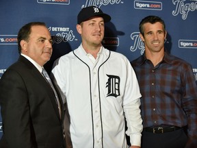 Detroit Tigers general manager Al Avila, left, pitcher Jordan Zimmermann and manager Brad Ausmus, right, pose for a photo after a news conference in Detroit, Monday, Nov. 30, 2015. Free agent Zimmermann has finalized a $110 million, five-year contract with the Detroit Tigers. (Robin Buckson/Detroit News via AP)