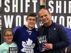 Tie Domi poses with Maya Williams, 10, and her brother Evan Williams, 13, during a book signing event at WalMart on Dougall Road Wednesday November 11, 2015. The amiable Domi spent time with each fan, signing his book and chatting about the NHL and his early days in Belle River and the OHL. (NICK BRANCACCIO/Windsor Star)
