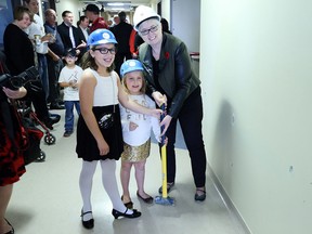 Gabby and Daniella Pizzuti along with Margaret Anderson, executive directory Ronald McDonald House Charities Southwestern Ontario begin the demolition process during a ceremony to officially start construction of the new Ronald McDonald house at Windsor Regional Hospital in Windsor, Ontario.