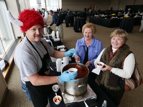 Windsor firefighter Bill Hopkins, left, serves up chili to Mary Ann Dafoe, and Karen Hodgson during the Windsor Firefighters Annual Chilifest held at the St. Clair Centre for the Arts on November 13, 2015. Chili from over 40 local restaurants was served by Windsor Firefighters and proceeds support the Windsor Firefighters Benefit Fund & Sparky’s Toy Drive. (JASON KRYK/WINDSOR STAR)