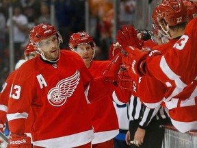 Detroit's Pavel Datsyuk, left, celebrates his goal against the Winnipeg Jets in the first period in Detroit, Tuesday, Nov. 12, 2013. (AP Photo/Paul Sancya)