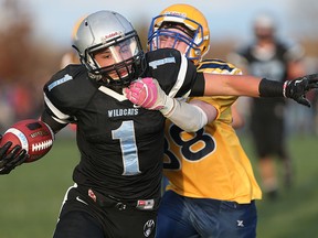 Villanova Wildcats Jacob Savoni scores a touchdown while while defended by Ste. Anne Saints Mitchell Zimmerman during W.E.C.S.S.A.A. senior boys high school football action in Lakeshore, Ontario on November 6, 2015.