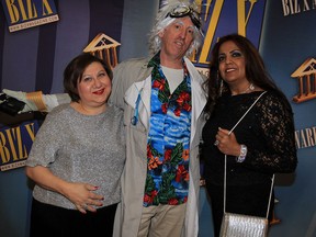 Performing artist Mark Lefebvre, centre, poses with Stella Ciancio, left, and Kamla Jaggernauth during the BizX Awards Gala at St. Clair College Centre for the Arts. Lefebvre is dressed as the character Doc Brown from the Back to the Future movie franchise.