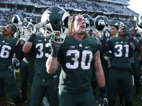Michigan State Spartans players celebrate after the game against the Maryland Terrapins at Spartan Stadium on November 14, 2015 in East Lansing, Michigan. Michigan State defeated Maryland 24-7. (Photo by Joe Robbins/Getty Images)